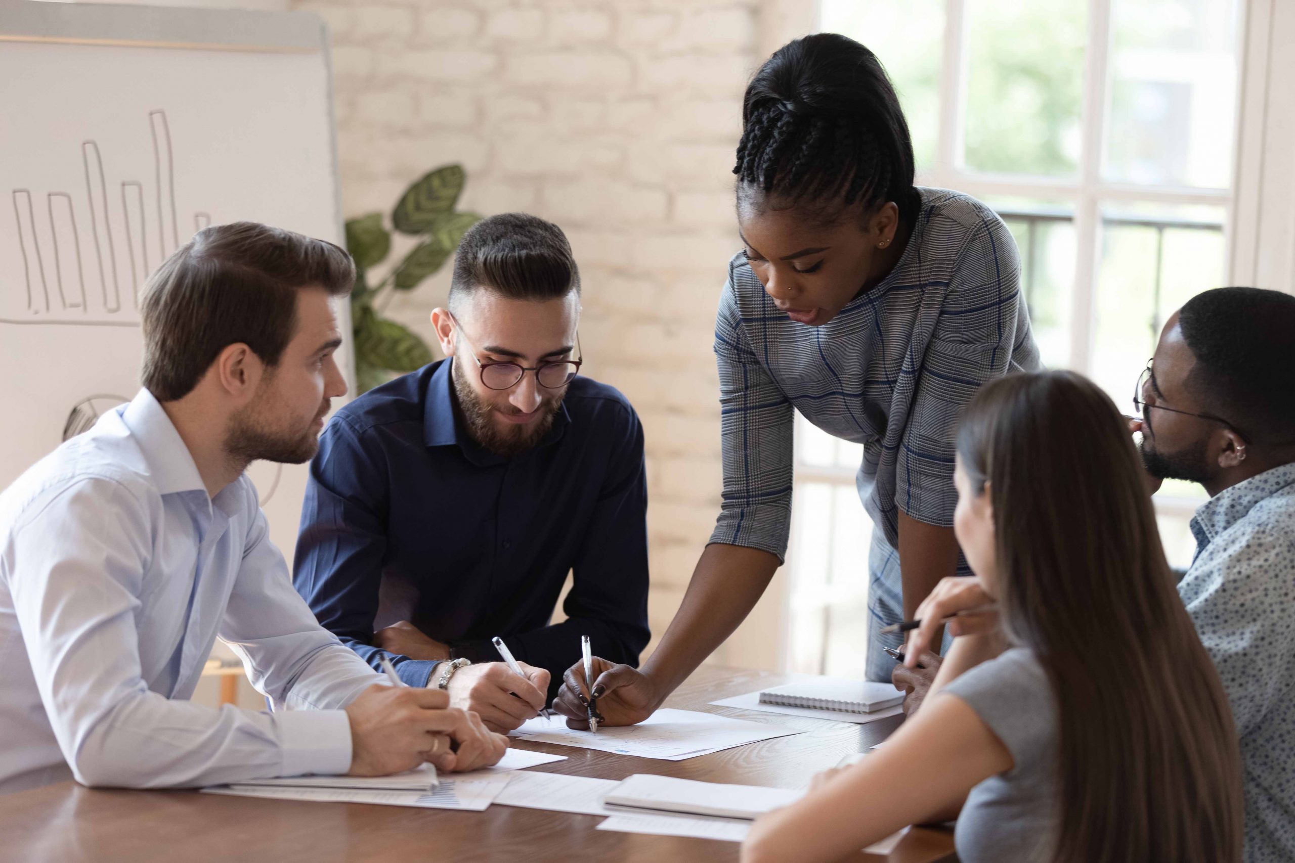 A group of professionals are gathered in a meeting.