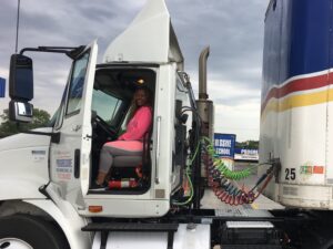Tina sits in the driver's seat of her big rig.