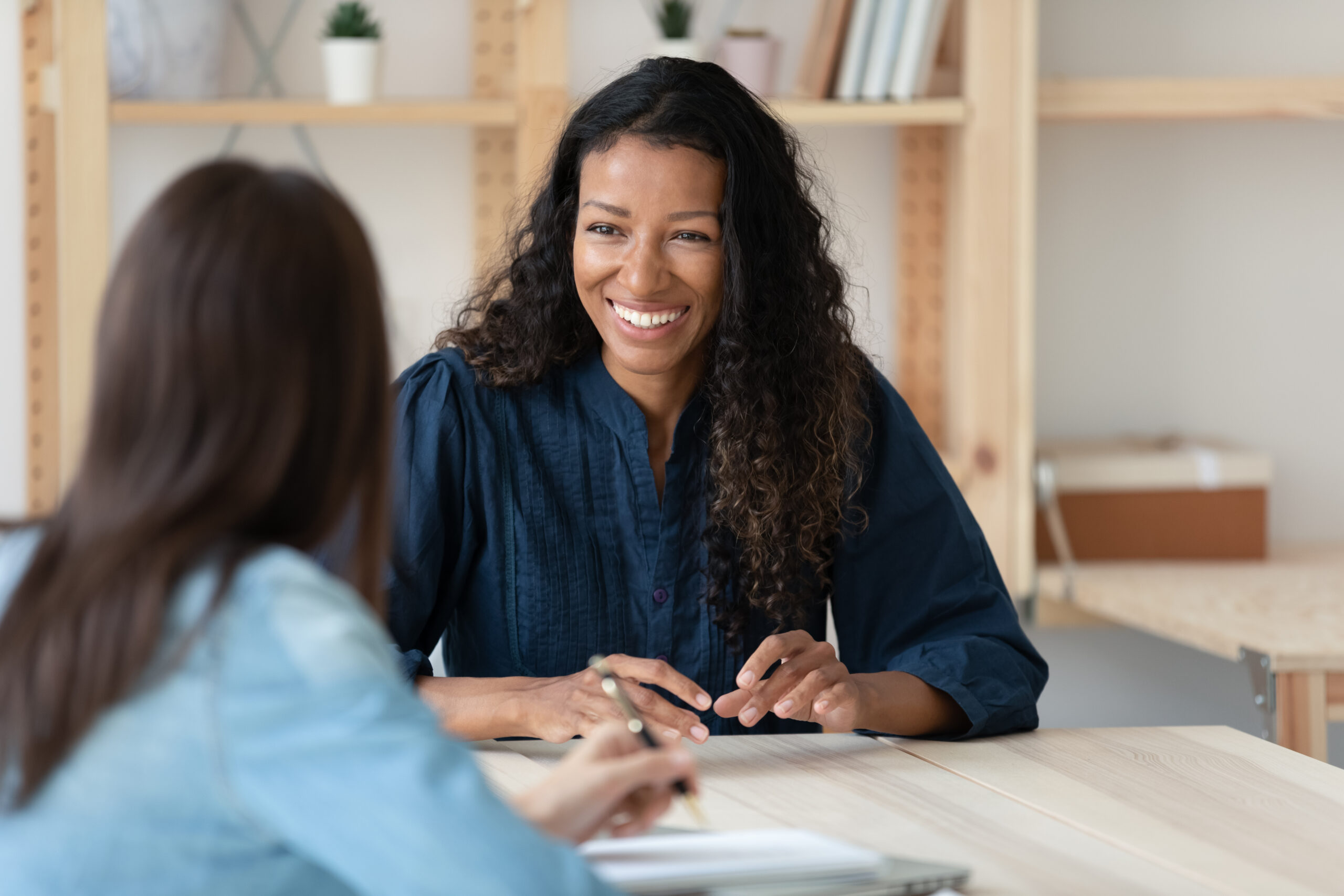 Smiling,Young,African,American,Woman,Talk,With,Female,Colleagues,Brainstorm